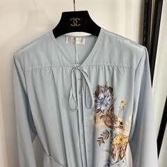 Zimmermann floral and bird print long-sleeved dress with a belted waist.