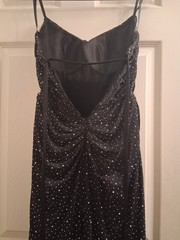 Black dress adorned with rhinestones,High thigh-slit and open back piece
