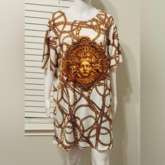 A dress with a Medusa head print and gold chains. This loose-fitting T-shirt
