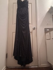 Black dress adorned with rhinestones,High thigh-slit and open back piece
